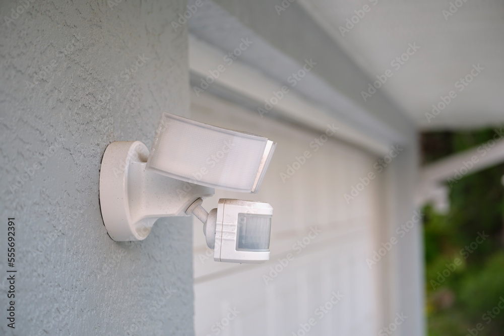 Motion sensor with light detector mounted on exterior wall of private ... Motion sensor with light detector mounted on exterior wall of private ...